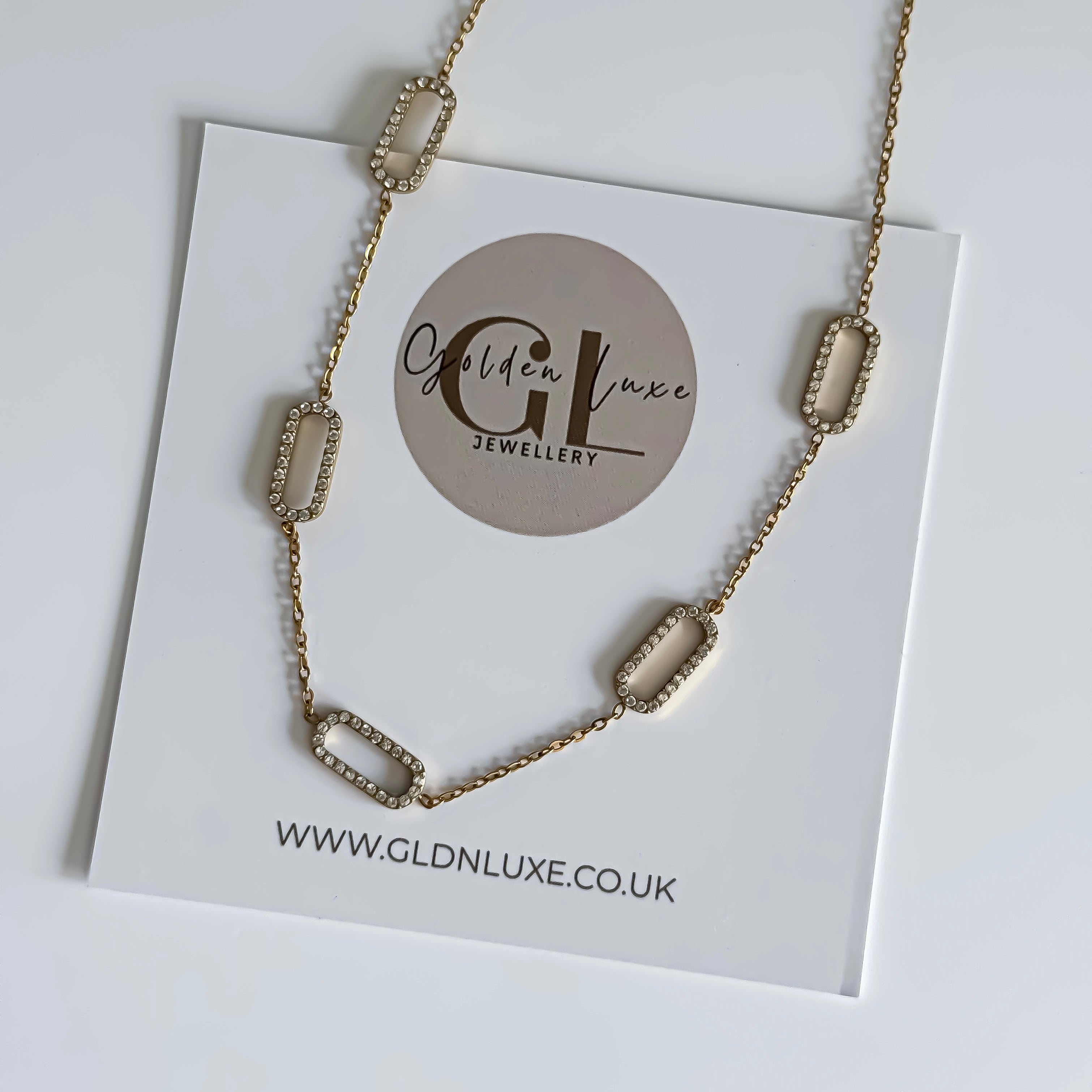 Gold necklace on a card with Golden Luxe Jewellery branding