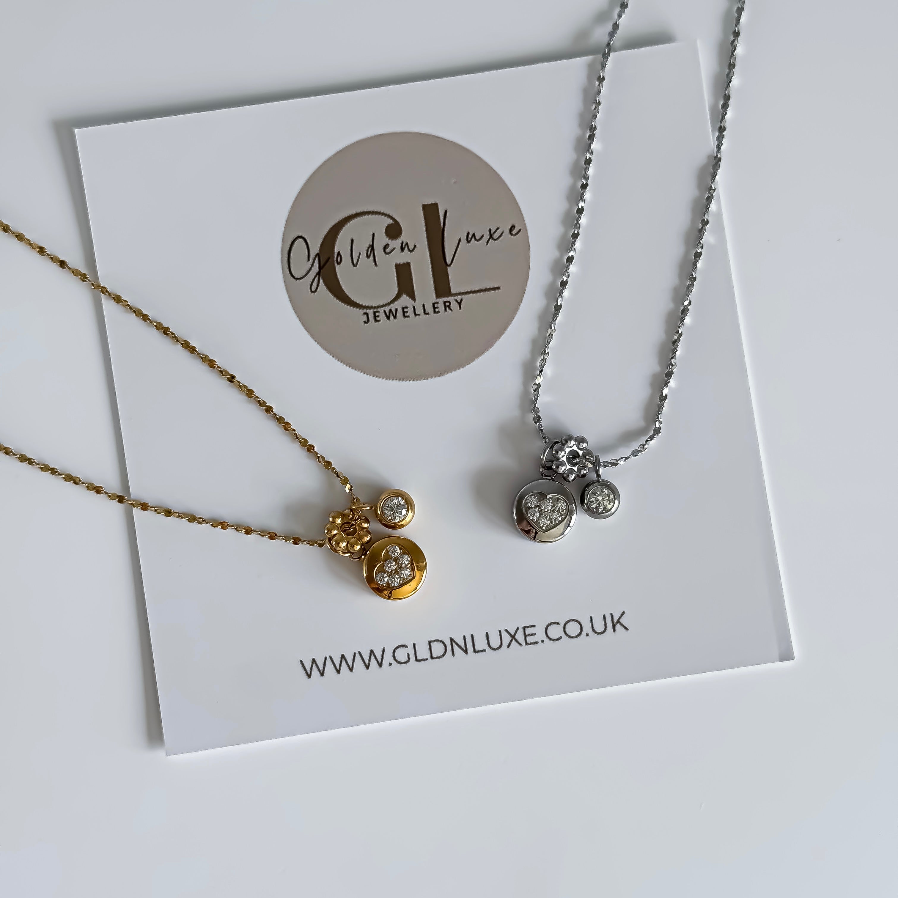 Two necklaces on a card with Golden Luxe Jewellery branding.
