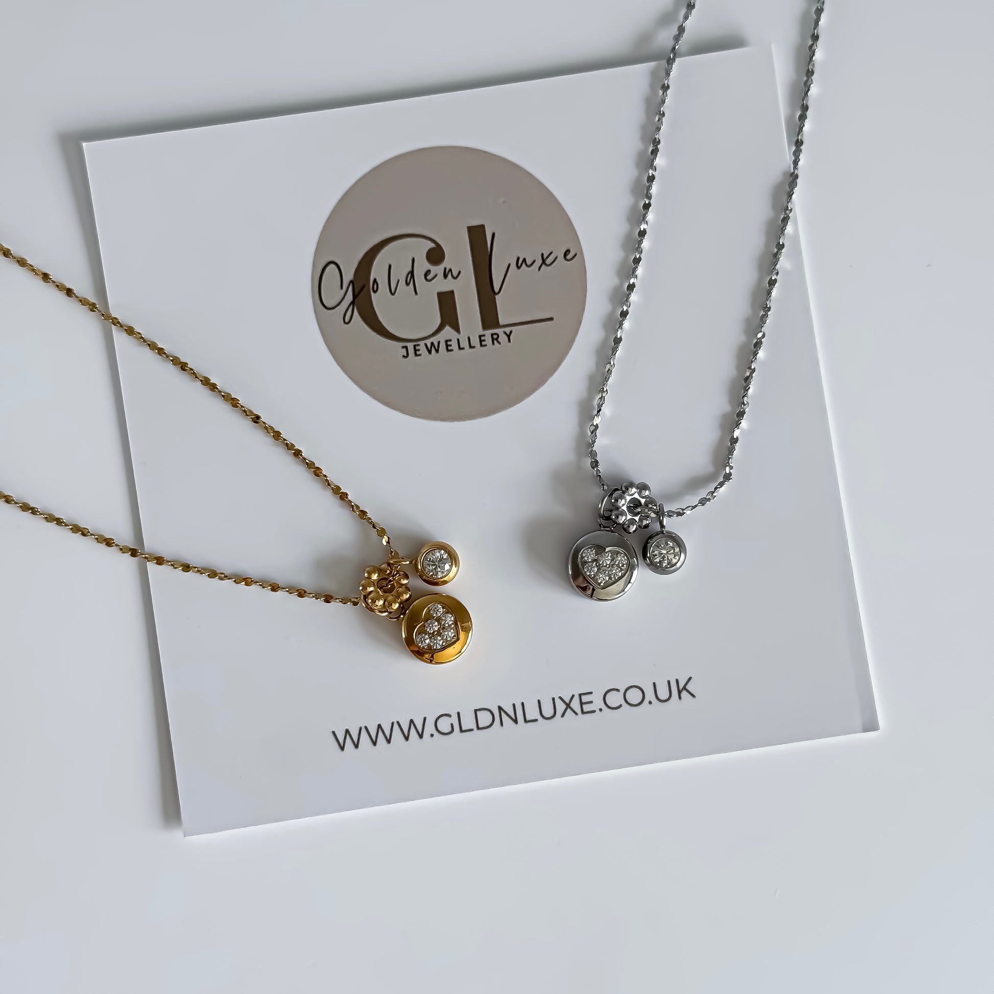 Two necklaces on a card with Golden Luxe Jewellery branding.