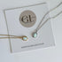 Two opal pendant necklaces on a card with Golden Luxe Jewellery branding.