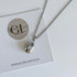 Silver necklace with a pendant on a card featuring Golden Luxe Jewellery branding.