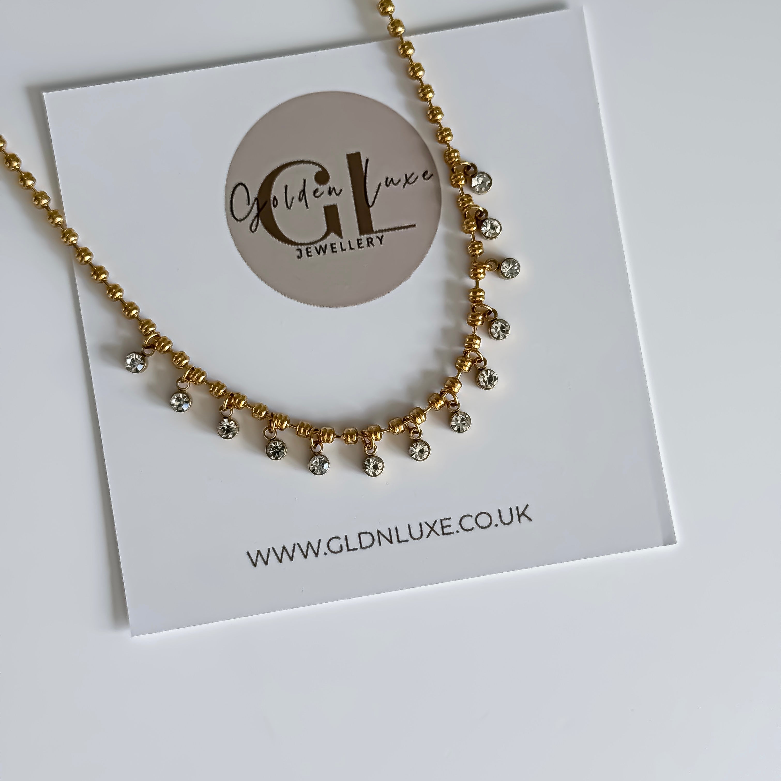 Gold necklace on a card with Golden Luxe Jewellery branding