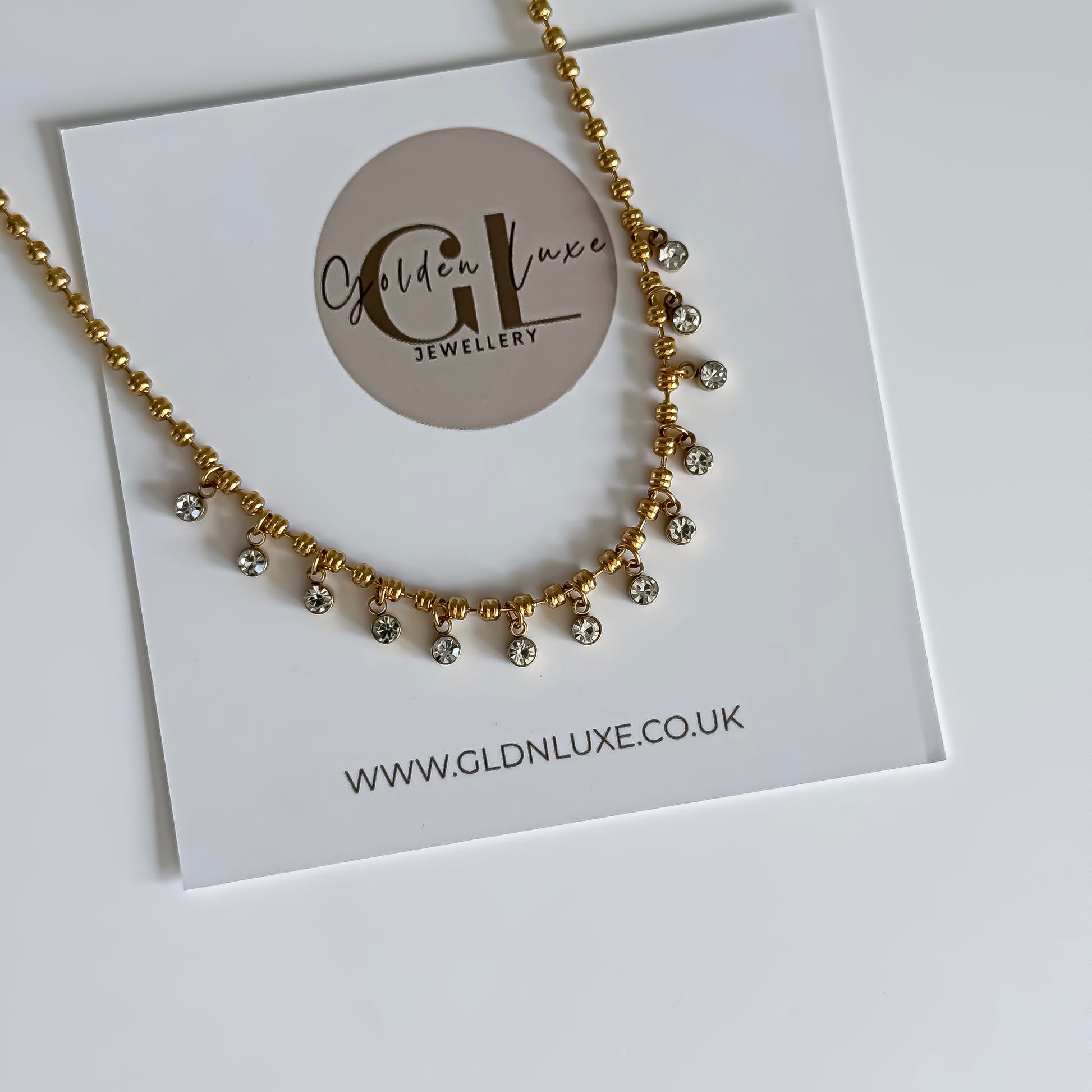Gold necklace on a card with Golden Luxe Jewellery branding