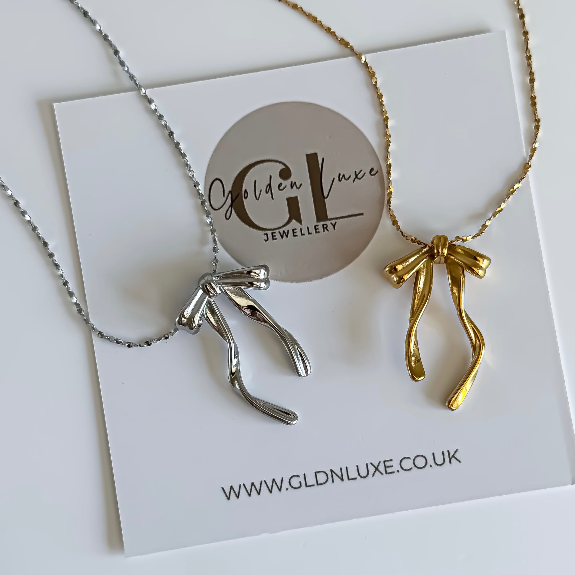 Two necklaces, one silver and one gold, on a card with 'Golden Luxe Jewellery' branding.