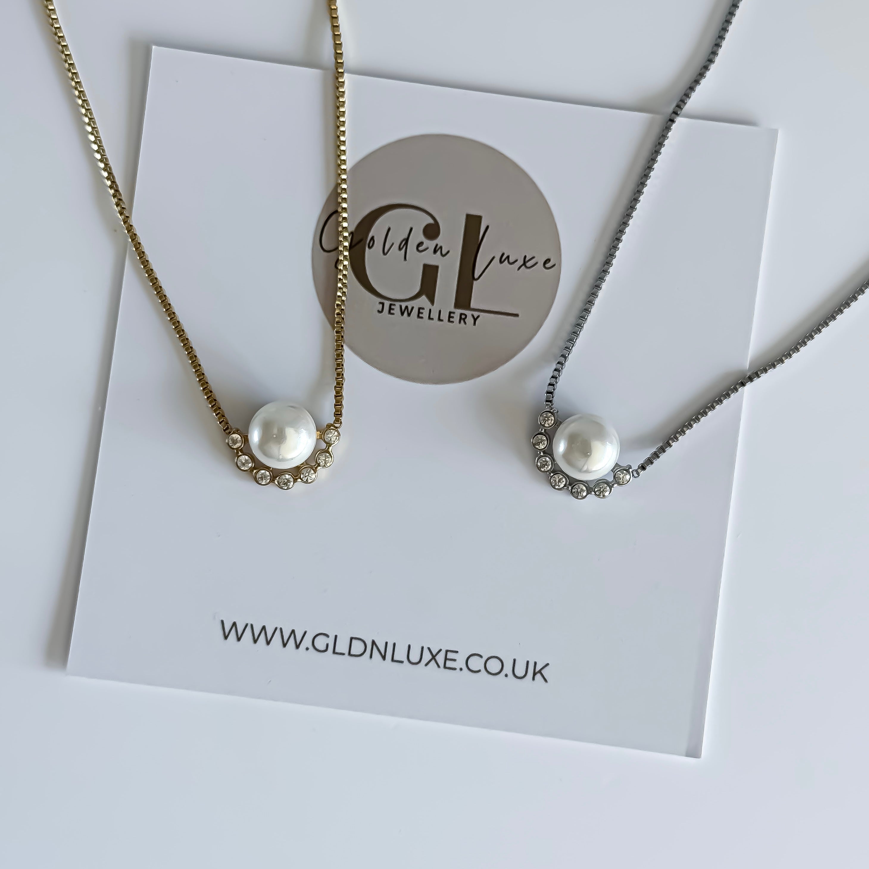 Two pearl necklaces on a Golden Luxe Jewellery card with a white background
