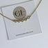 Gold necklace with heart-shaped charms on a Golden Luxe Jewellery card.