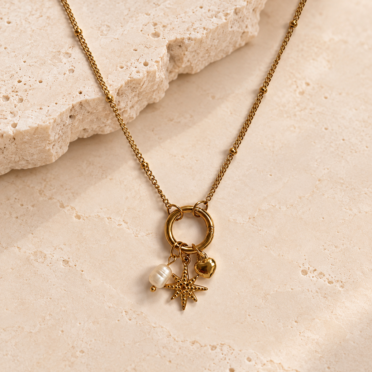 Gold dotty carabiner necklace personalised with pearl, starburst and heart charms