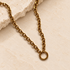 Gold chunky carabiner necklace with statement chain and round clasp