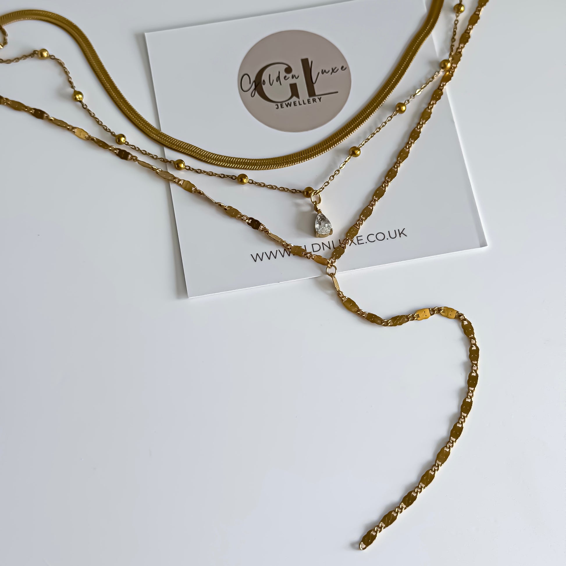 Gold layered necklace on a white card with 'Golden Luxe Jewellery' branding.