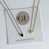 Two necklaces on a Golden Luxe Jewellery card with a gold and silver heart pendant.