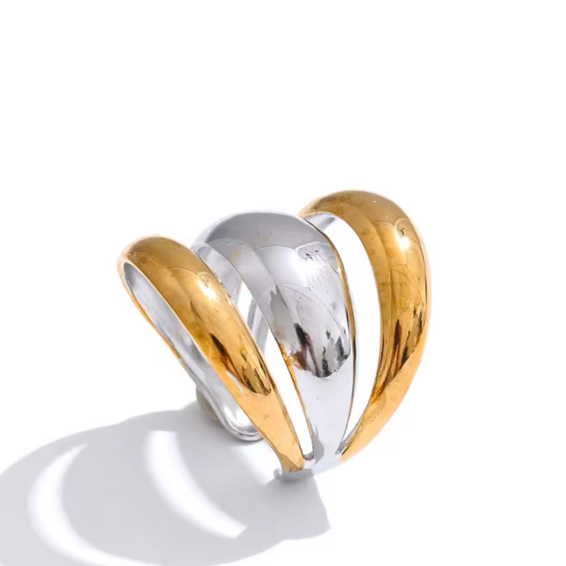 Mixed metal gold and silver adjustable ring on a white background
