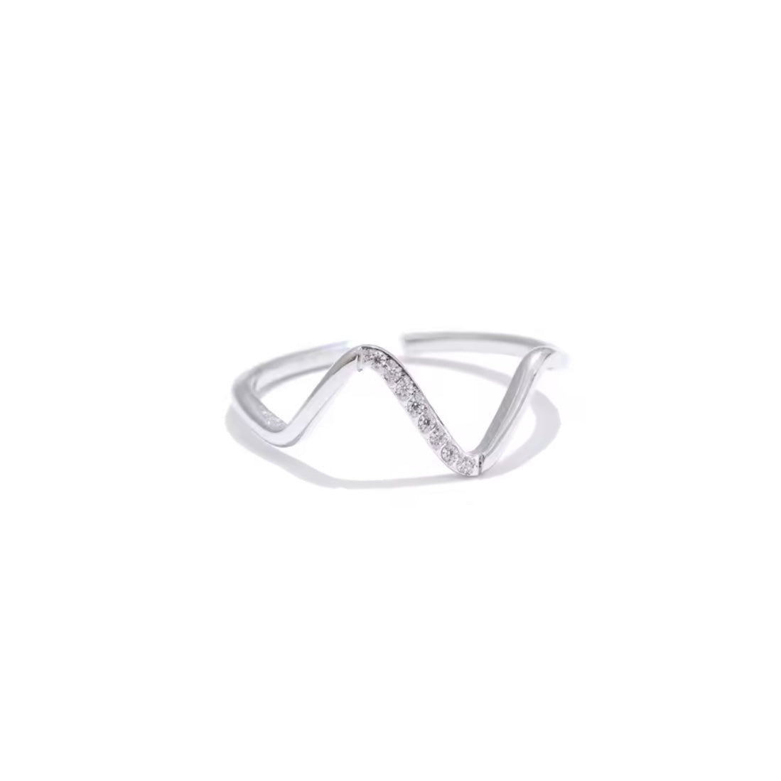 Silver ring with a wavy design on a white background