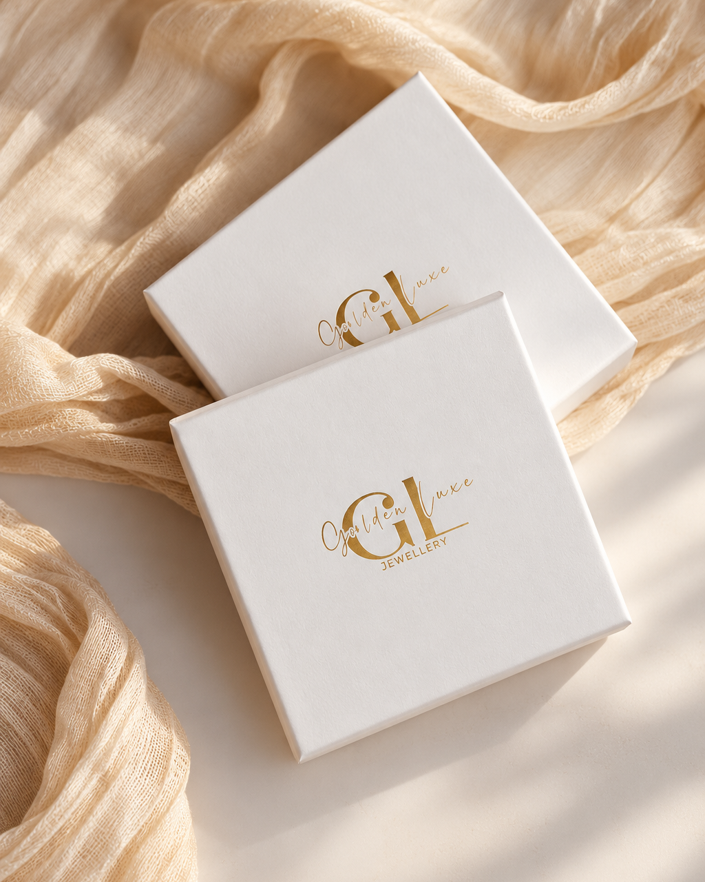 Large white Golden Luxe jewellery gift box with gold logo on soft neutral background.