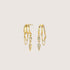 Gold hoop earrings with chain and gemstone details on a beige background