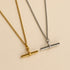 Two minimalist toggle bar necklaces, one in polished gold and one in silver, displayed on a warm beige background.