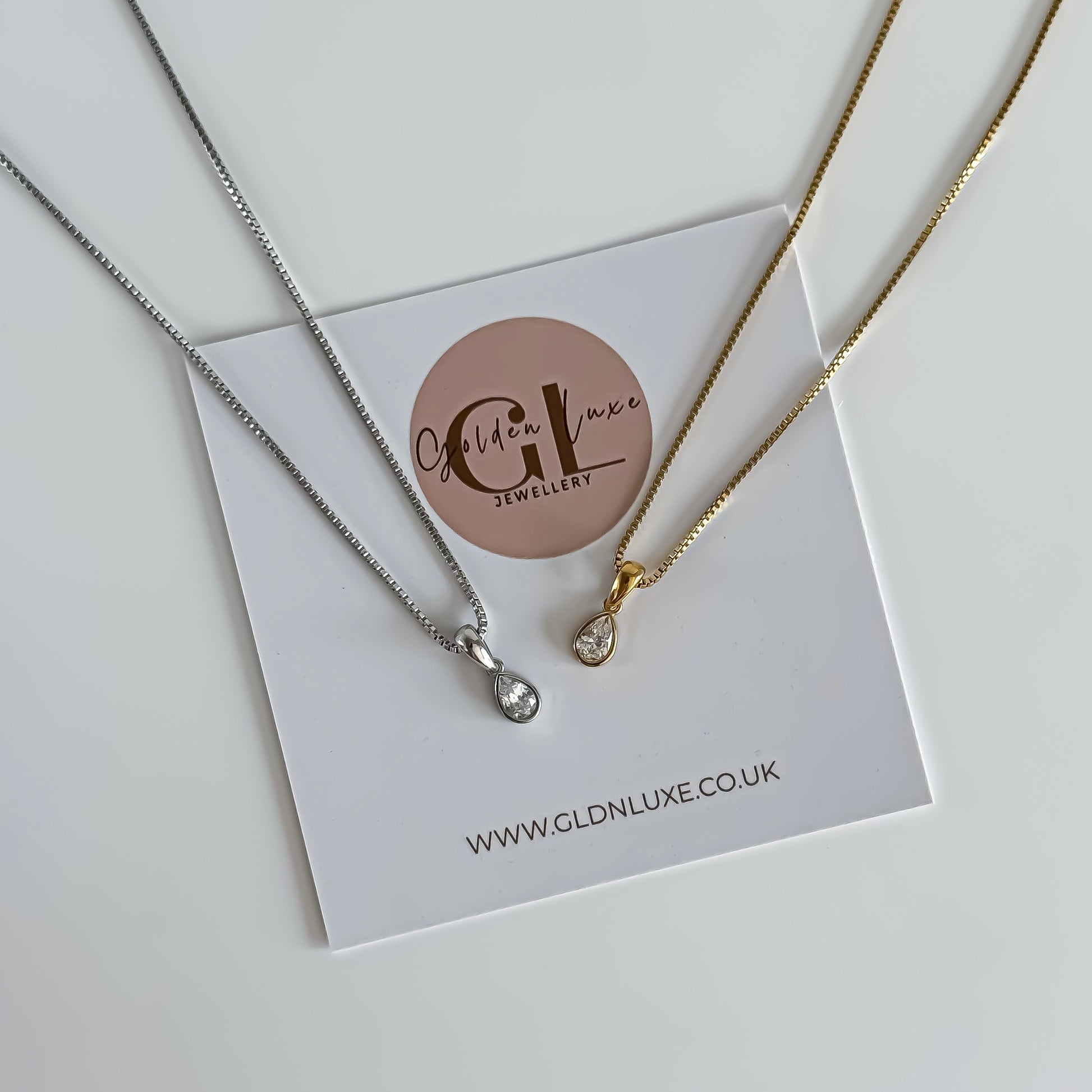 Two stainless steel necklaces on a card with Golden Luxe Jewellery branding.